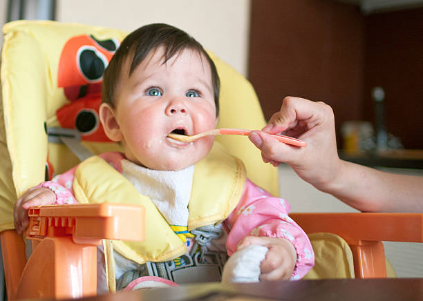 istock mother feeds the little daughter 176522856