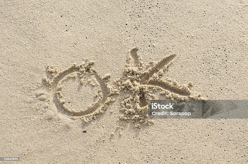 OK - sand writing on the beach OK - sand writing concept on the beach Beach Stock Photo