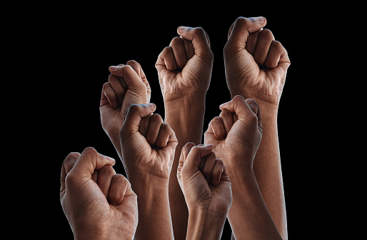 Fist, group protest and together by black background for human rights, power or solidarity for equality. People, support and strong with hands, air or change for motivation, goal or fight for justice