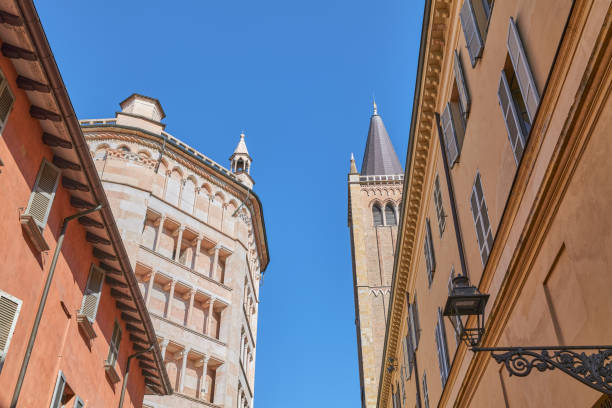 Parma, Italy, upward view of the octagonal Baptistery of pink marble in Lombard Romanesque style and the Cathedral bell tower