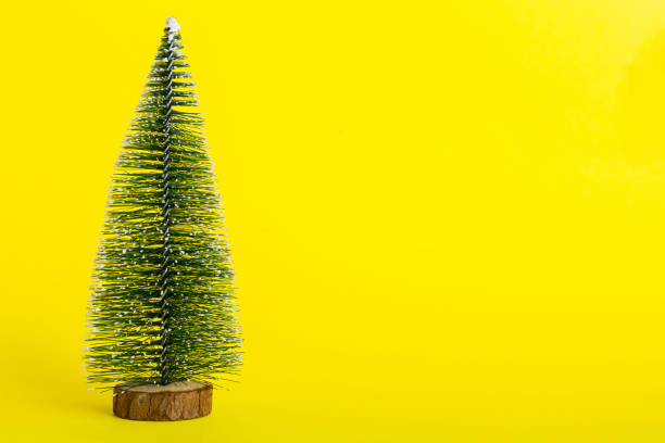 istock One small Christmas tree on colored background. new year decoration with copy space 1765237533