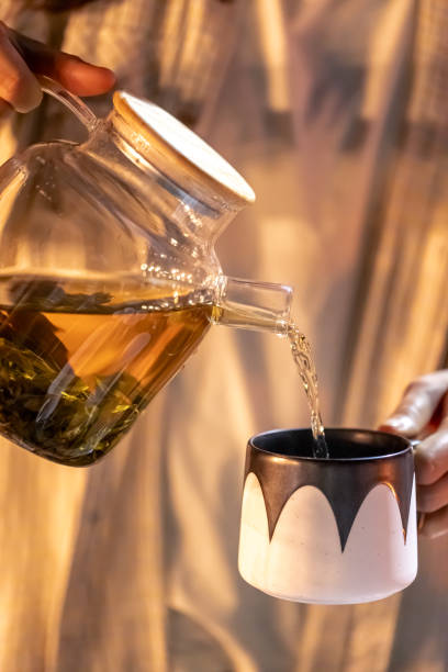 istock A woman pours tea into a cup late at night. 1765240762
