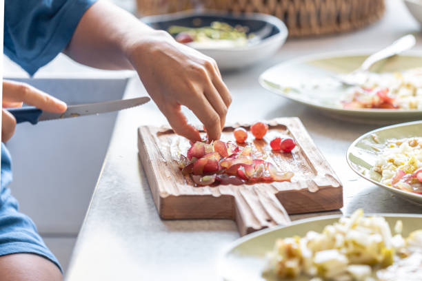 istock A woman cuts grapes on a cutting board. 1765240764