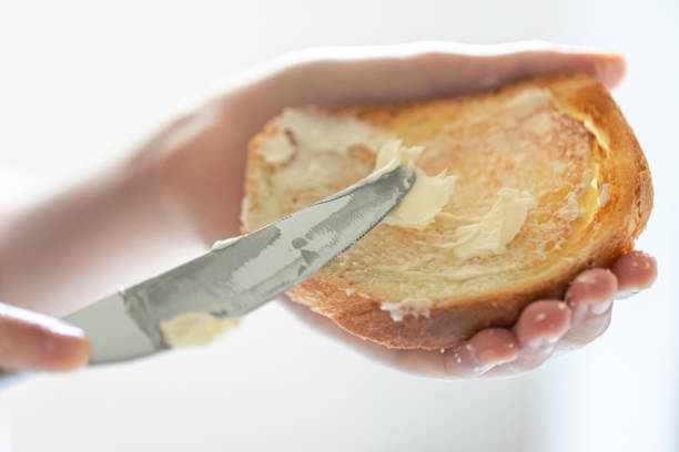 istock A piece of bread with butter in a woman's hand. 1765241325