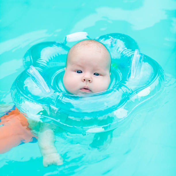 Baby swimming stock photo