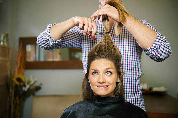 doenças mulher na loja de cabeleireiro cortar cabelo comprido - biting lip imagens e fotografias de stock