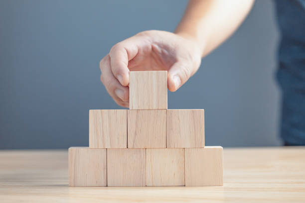 istock hand of a businessman stacking wood empty eight blocks with copy space for text or symbols, development concept for growth success process. 1765252736