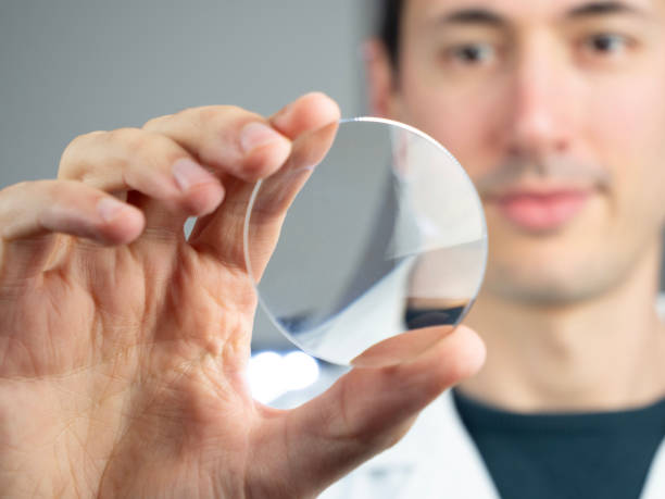 istock One Young Man Optician optometrist holds glass lens eyewear for quality control check 1765261964