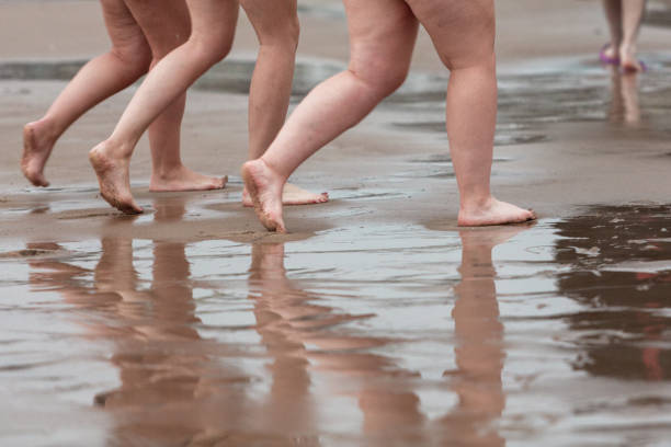 istock legs of people walking after cold water dipping 1765262493