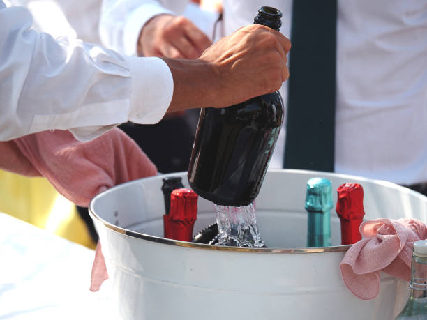 catering staff serving cold white sparkling wine prosecco to event participants in private event outdoors