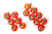 Fresh juicy red cherry tomato bunches closeup isolated on white background.