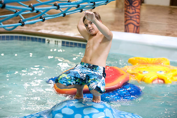 istock Young boy playing at the indoor water park 176527358