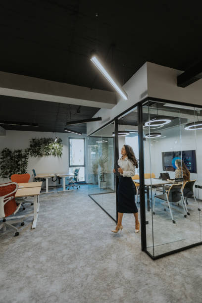 istock Young woman with digital tablet walking in the modern office 1765274597