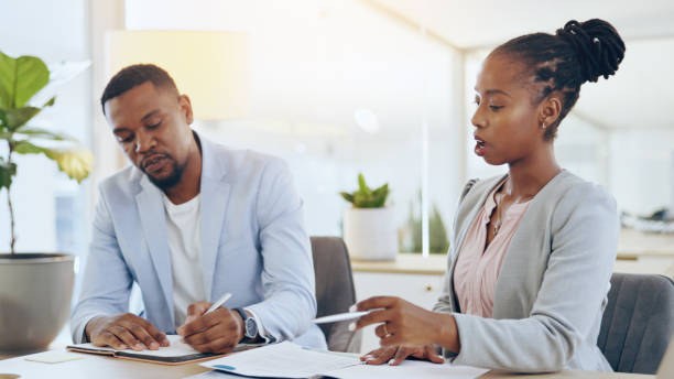 istock Business people, teamwork and man with black woman, documents and cooperation in a workplace. African person, employee or manager with paperwork, planning and collaboration with brainstorming or idea 1765285787