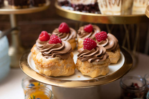 istock Raspberry dessert. Tray of fruit muffins. Bakery background. Chocolate cream cupcake. 1765288128