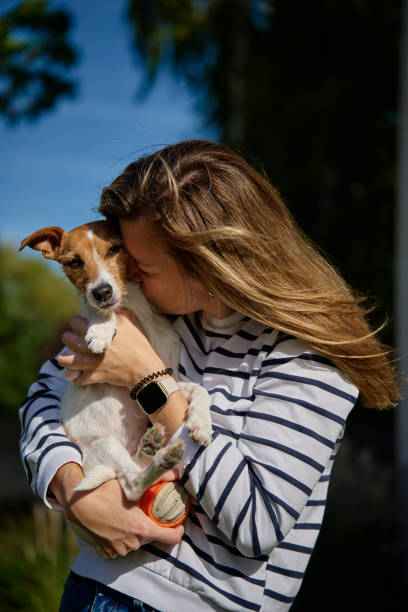 istock Woman hugging and kissing her dog 1765291847