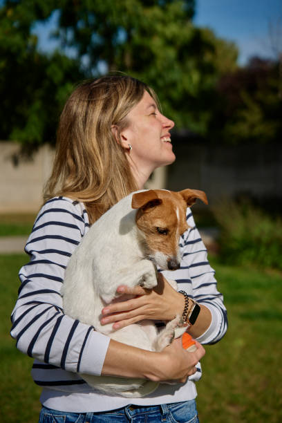 istock Woman hugging and kissing her dog 1765291848