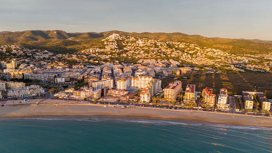 This aerial drone photo shows the boulevard at the coastal town of Peniscola in Spain. There are many hotels located at the touristic coastline.