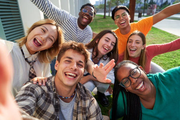 istock Multiethnic classmate taking a selfie outside of the university, looking at camera cheerfully. 1765315316