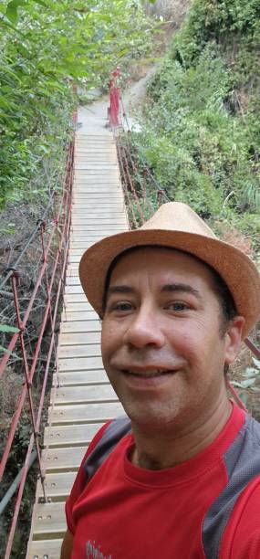 istock young man doing crossing a bridge on a mountain route 1765322643