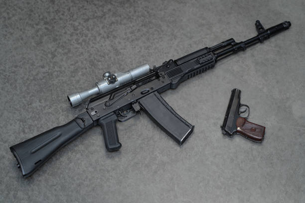 istock Rifle with a old fashioned optical sight and retro pistol on the gray background 1765328829