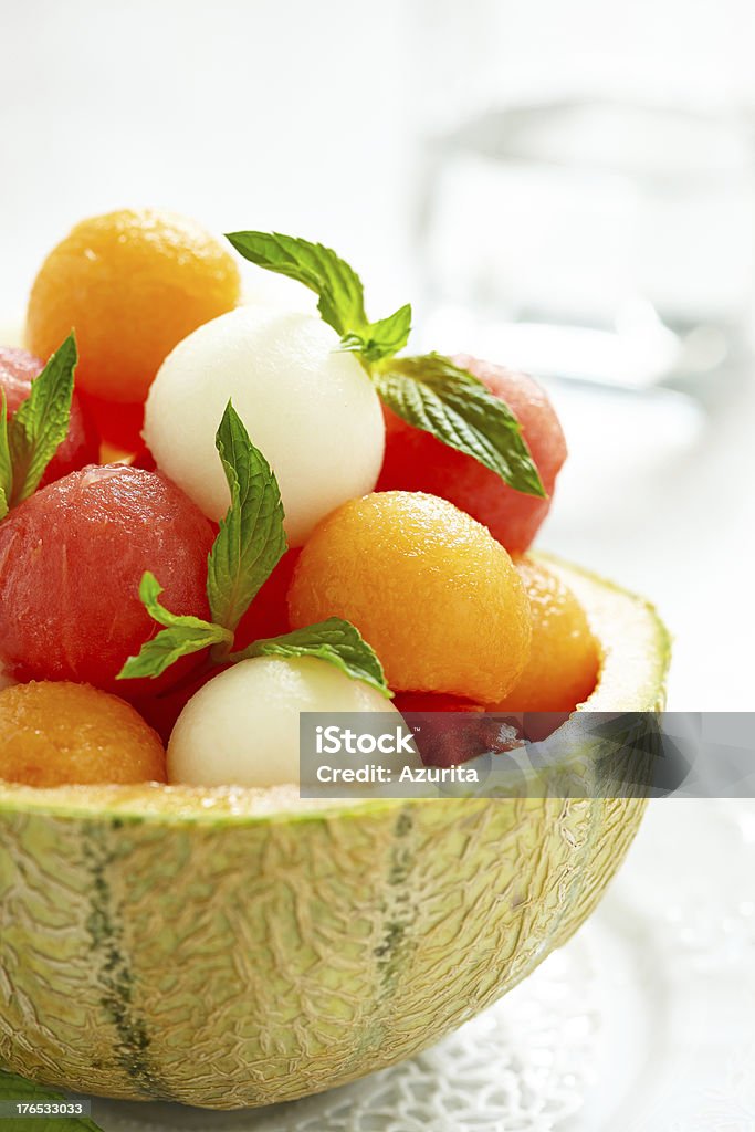 Fruit salad with watermelon and melon balls Fruit salad with melon and watermelon balls in cantaloupe bowl Melon Stock Photo