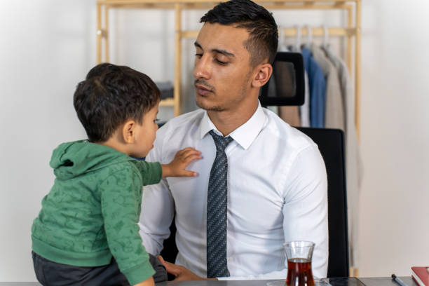 istock Father and son having fun at home at the work table. 1765337828