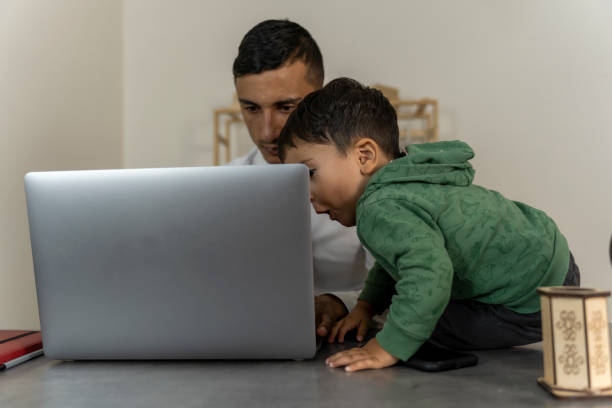 istock Father and son at home at the desk. 1765344625