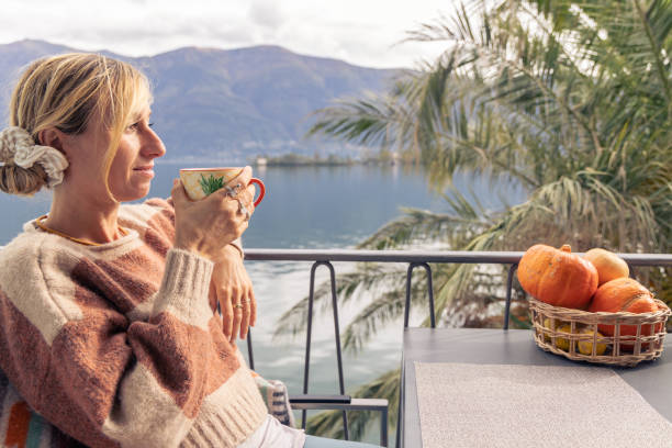 istock Woman having a cup of tea on her balcony, vacation rental 1765346309