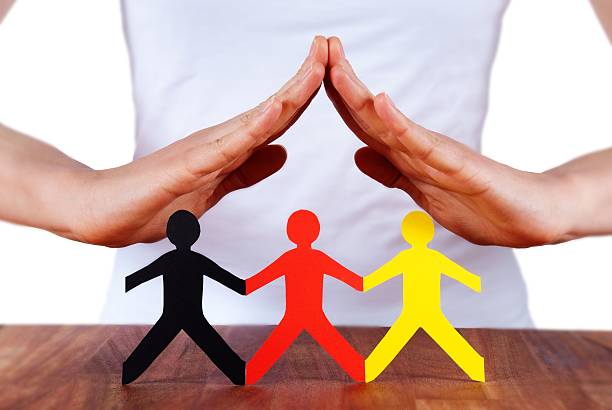 istock hands protecting colorful paper chain people 176534915
