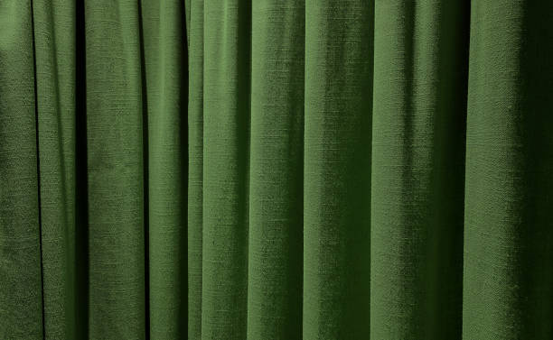 istock close up olive green curtains use as background. sack cloth texture drape for minimal interior design.  green natural linen drape curtains background. beautiful interior home design backdrop. 1765361912