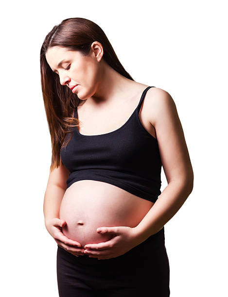 istock Beautiful pregnant looking her belly isolated 176536691