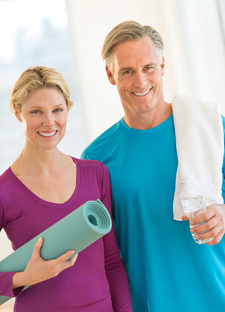 istock Couple With Water Bottle; Exercise Mat And Towel In Gym 176537248