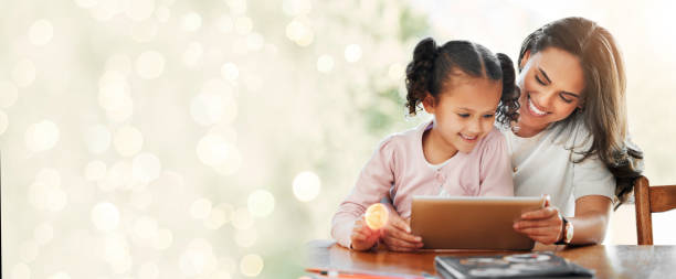 istock Mother, child and tablet for home education, e learning support and games for development on banner. Happy family, mom and girl on digital tech for kids video and school with lights overlay or mockup 1765375801