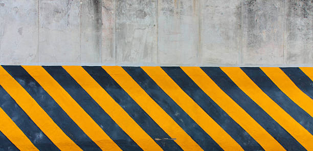 istock Yellow and black striped line on concrete wall 176538382