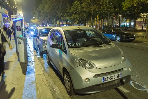 Paris, France. 19.10.2015: Shared electric car from the company Autolib stopped at the charging station on Boulevard Richard-Lenoir.