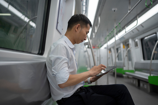 Business people take buses and use tablets