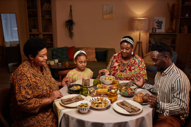 istock Black Family at Kwanzaa Dinner Table 1765389781
