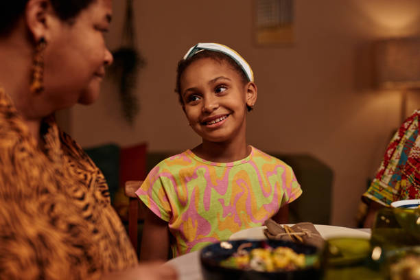 Girl Talking to Mother at Kwanzaa Dinner
