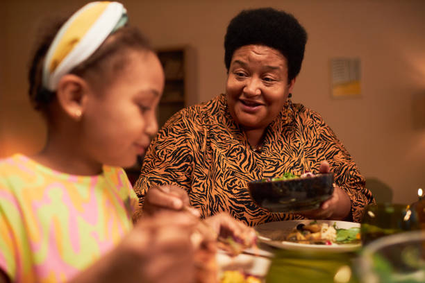 istock Grandmother Giving Daughter More Salad 1765390318
