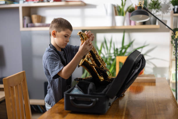 istock Boy saxophonist preparing to play 1765392632