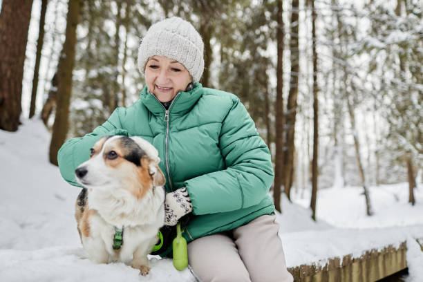 istock Woman Patting Corgi Dog 1765393802