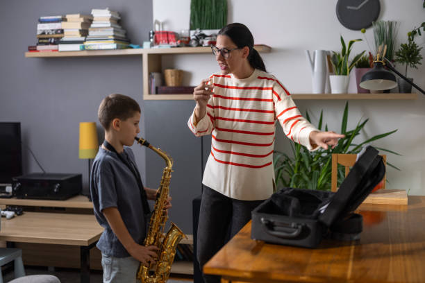 istock Boy saxophonist with teacher 1765400394