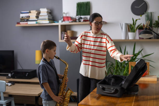 istock Boy saxophonist with teacher 1765400410