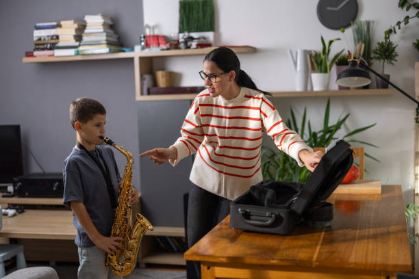 istock Boy saxophonist with teacher 1765400930