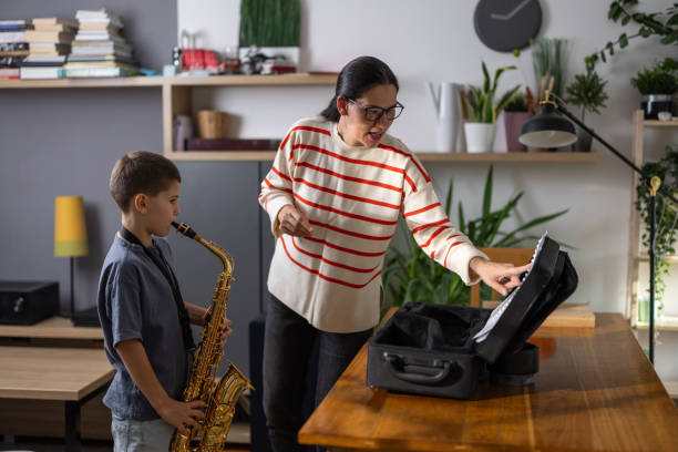 istock Boy saxophonist with teacher 1765404900