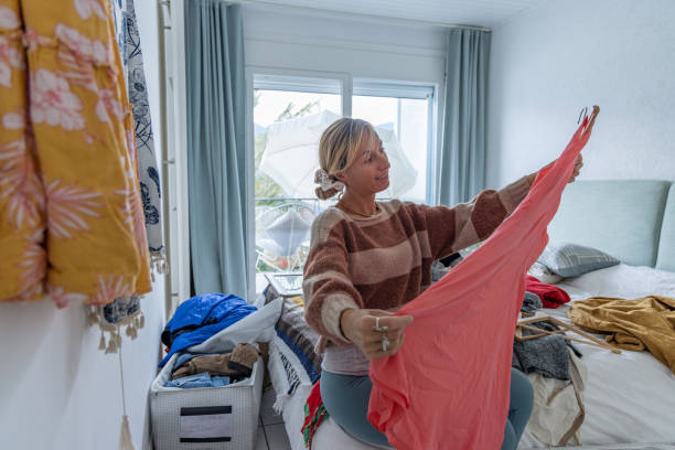 istock Woman working at her home based online store, she is selling used clothes 1765408868