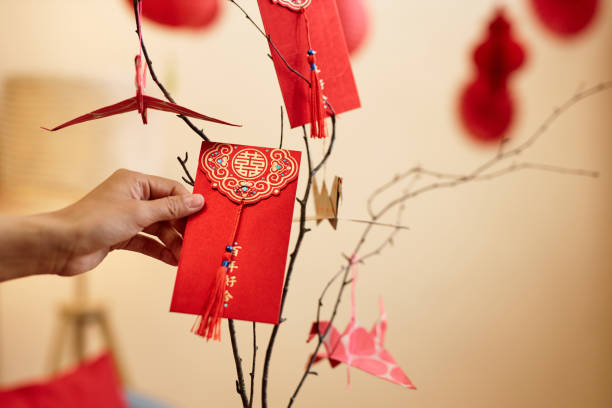 Hand holding hongbao envelope as Chinese New Year tradition