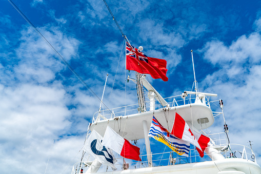 Vancouver, British Columbia - July 25, 2023:  White antennas, radar and other communication and navigation equipment on the mast of ship