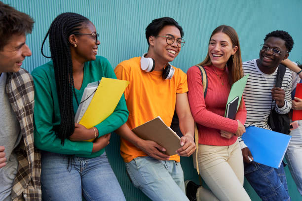istock Happy group of multiracial students gathering having fun, talking and laughing after school. 1765464482